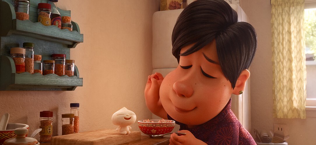 A woman and the little dumpling character at a kitchen table in Bao.