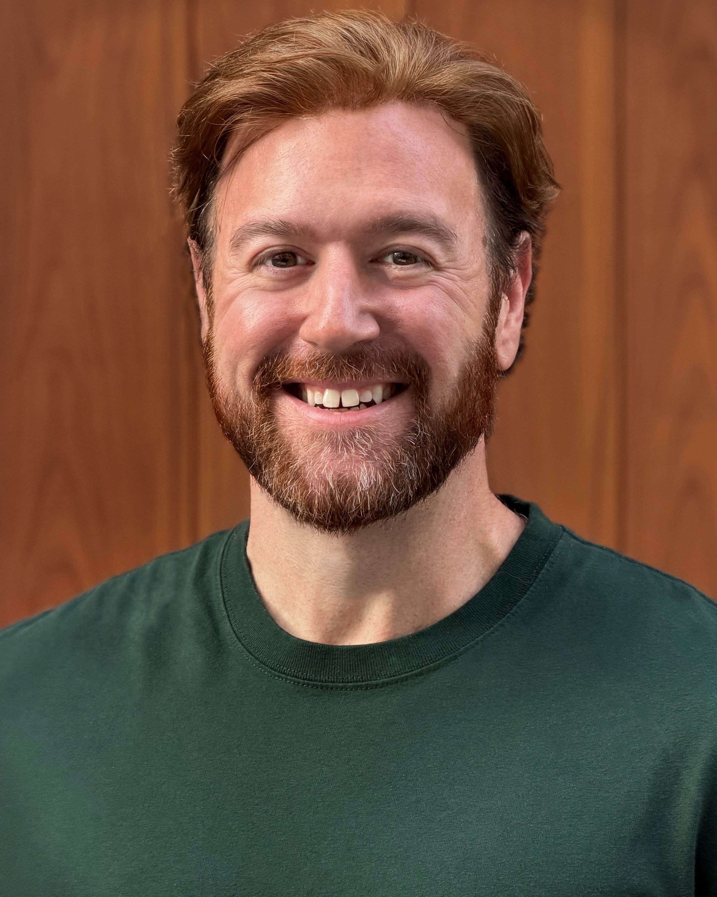 Will Saunders smiling in a green shirt.
